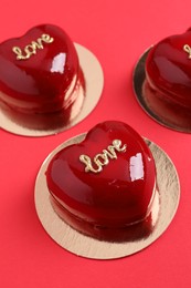 Photo of St. Valentine's Day. Delicious heart shaped cakes on red background, closeup