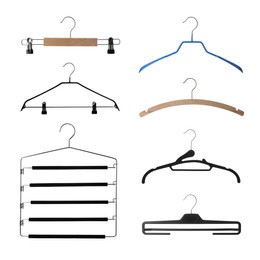 Image of Set with different empty hangers on white background