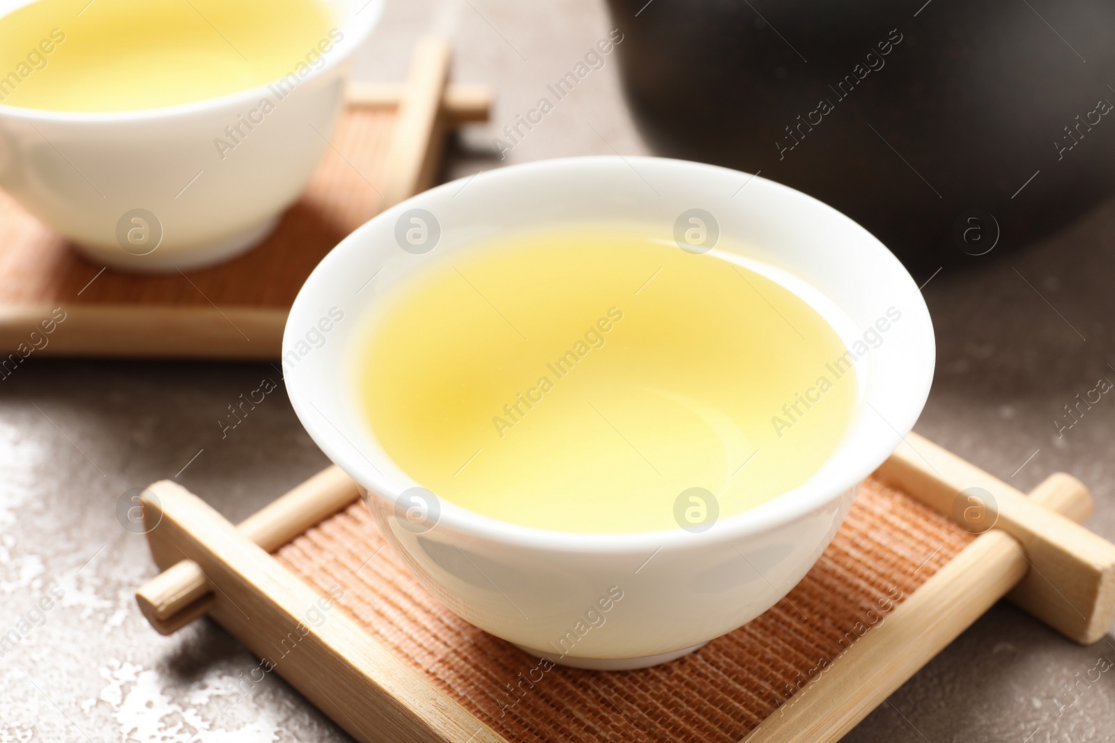 Photo of Cup of Tie Guan Yin oolong tea on table, closeup