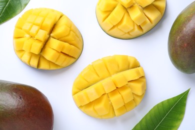 Photo of Ripe mangoes on white background, flat lay