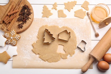 Photo of Making Christmas cookies. Flat lay composition with ingredients and raw dough on white wooden table