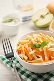 Photo of Delicious turnip salad served on white wooden table, closeup