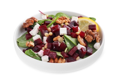 Photo of Delicious beet salad with feta cheese and walnuts in bowl isolated on white