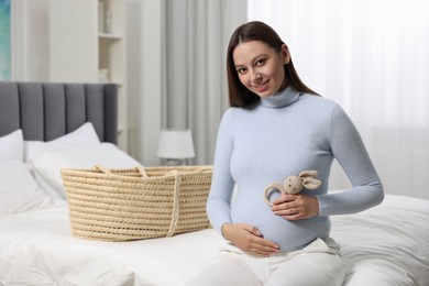 Photo of Beautiful pregnant woman with bunny toy in bedroom