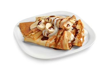 Photo of Thin pancakes with chocolate syrup, cream and banana on plate against white background