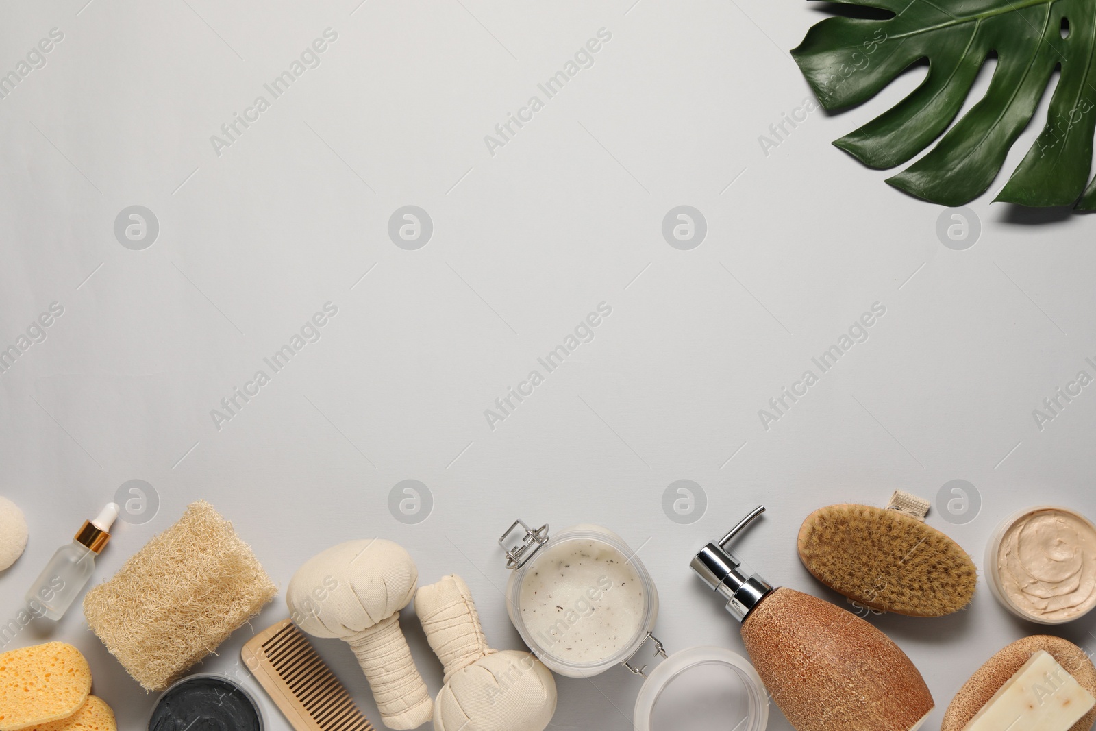 Photo of Bath accessories. Flat lay composition with personal care products on light grey background, space for text