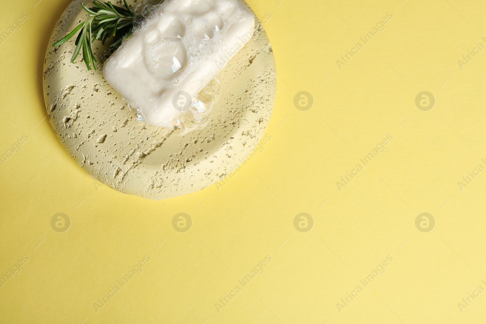 Photo of Soap dish with bar and foam on color background. Space for text