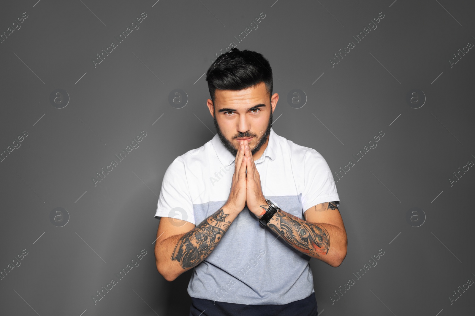 Photo of Portrait of handsome young man on gray background