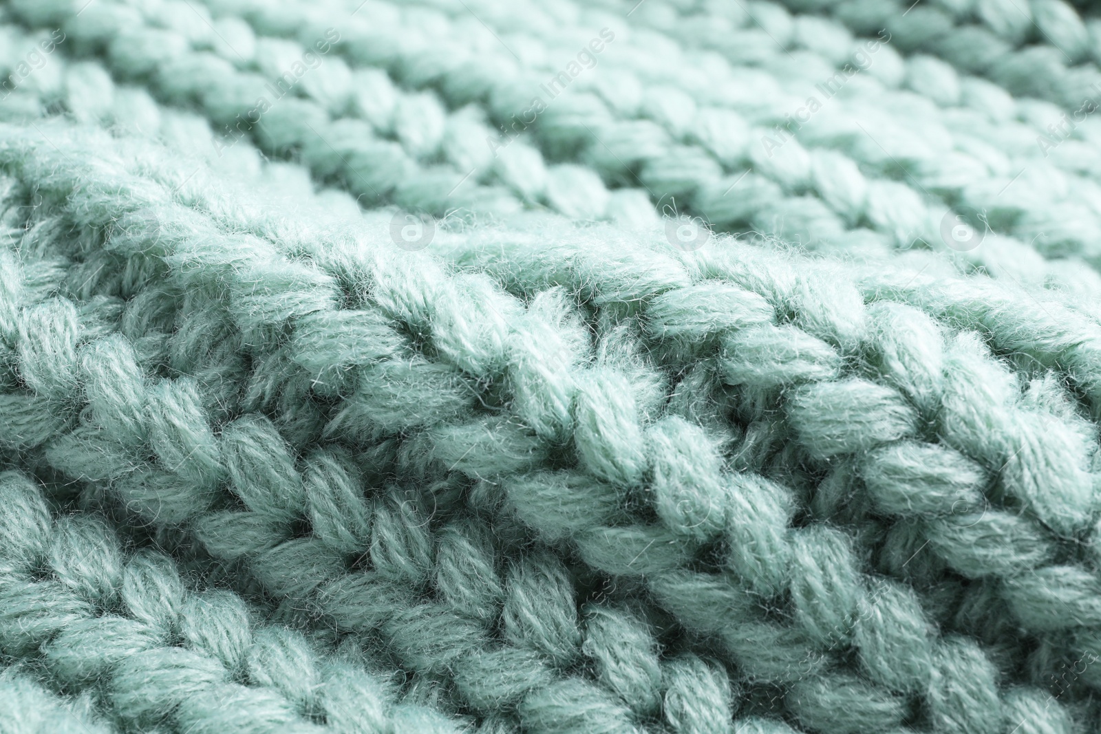 Photo of Warm knitted sweater as background, closeup view
