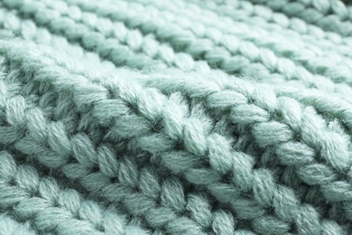 Warm knitted sweater as background, closeup view