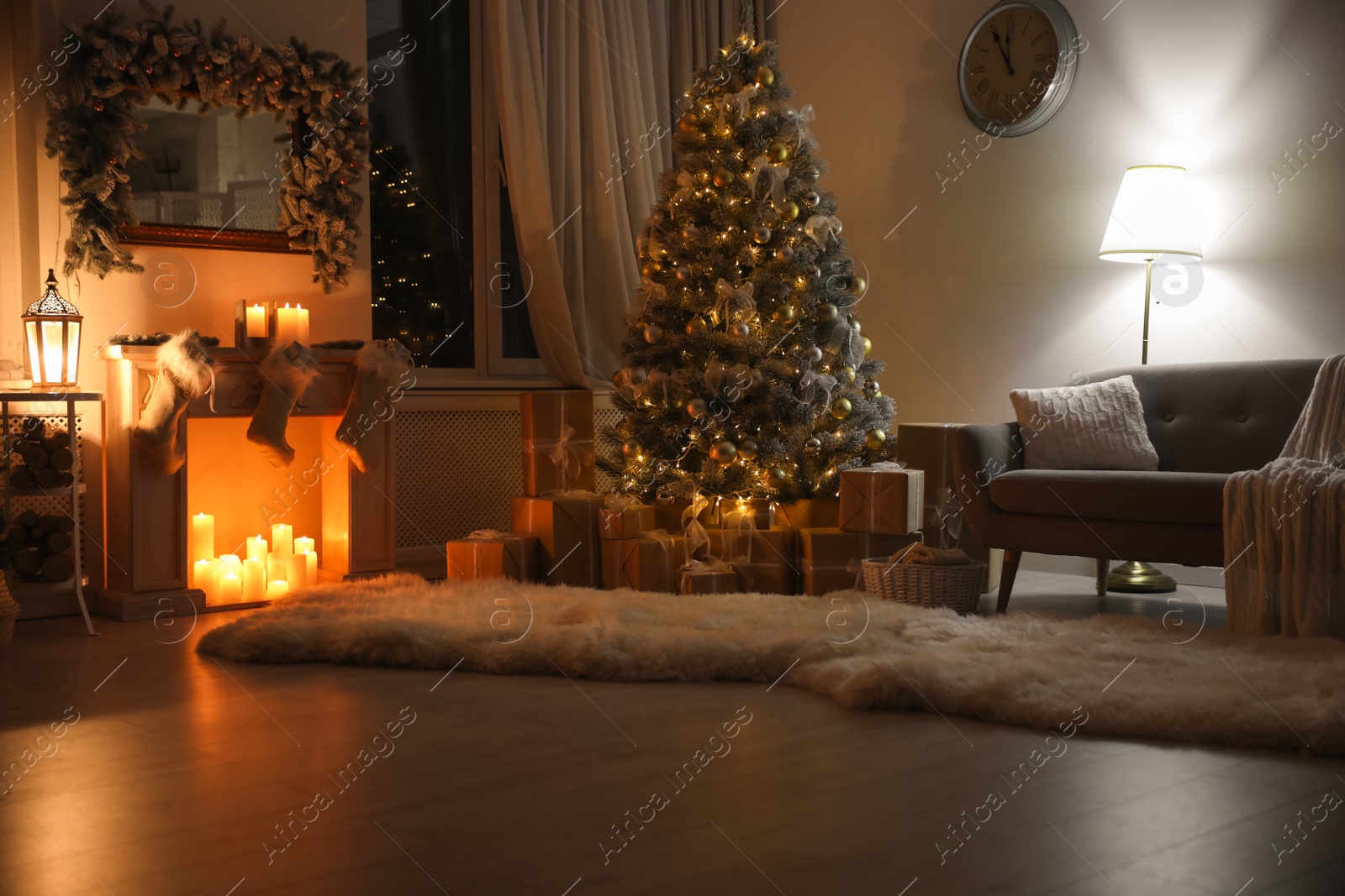 Photo of Stylish interior with beautiful Christmas tree and decorative fireplace at night