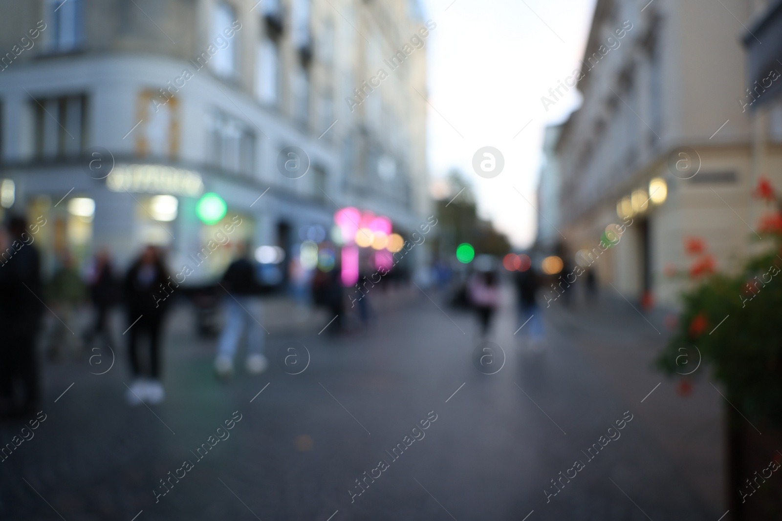 Photo of Blurred view of people walking on city street