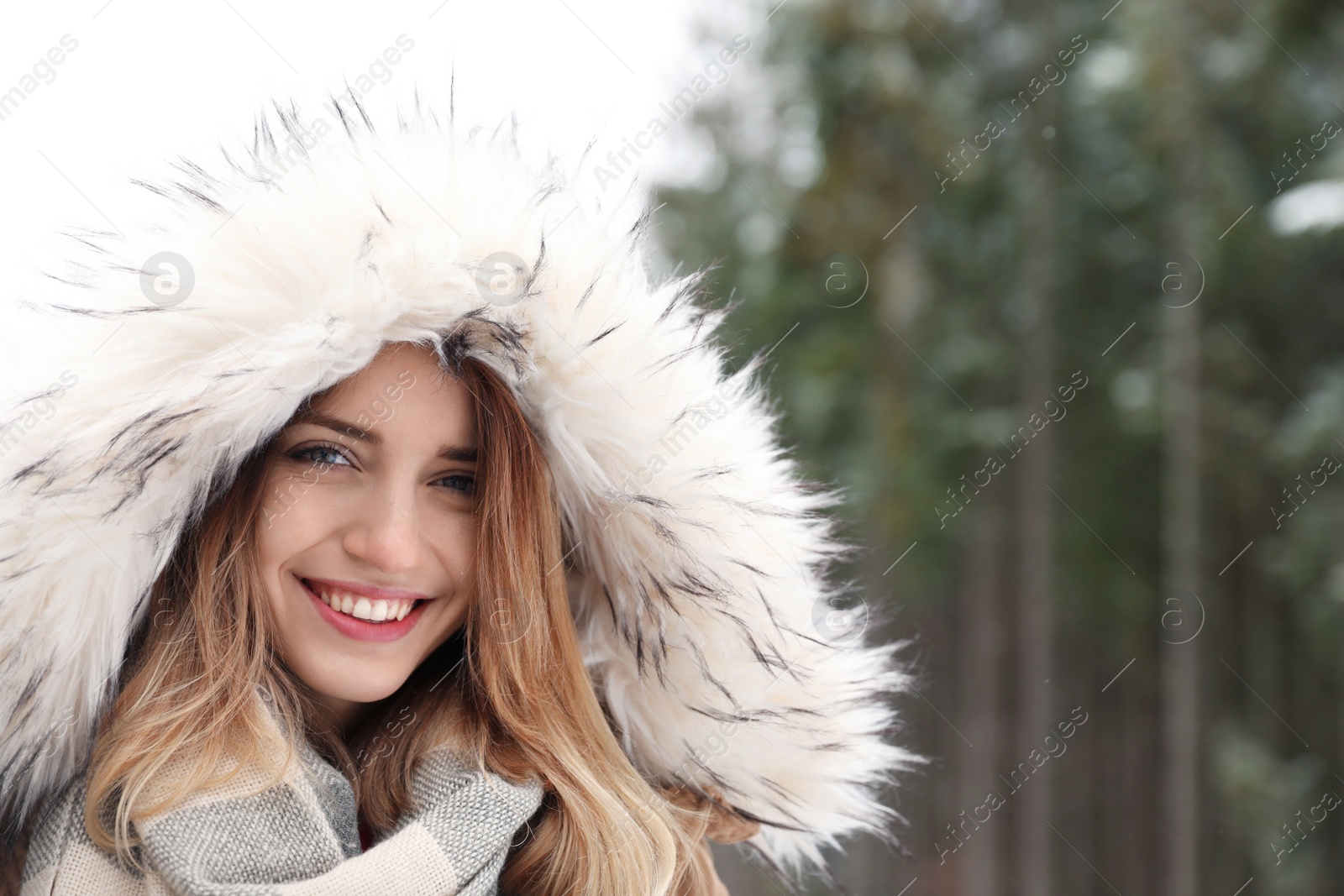 Photo of Young woman in warm clothes outdoors, space for text. Winter vacation