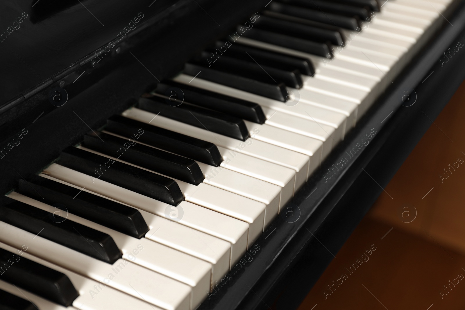 Photo of Modern piano with black and white keys, closeup