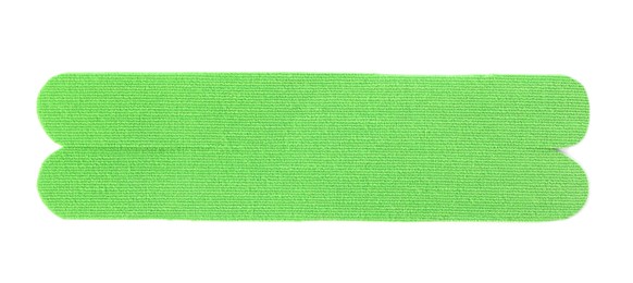 Photo of Green kinesio tape piece on white background, top view