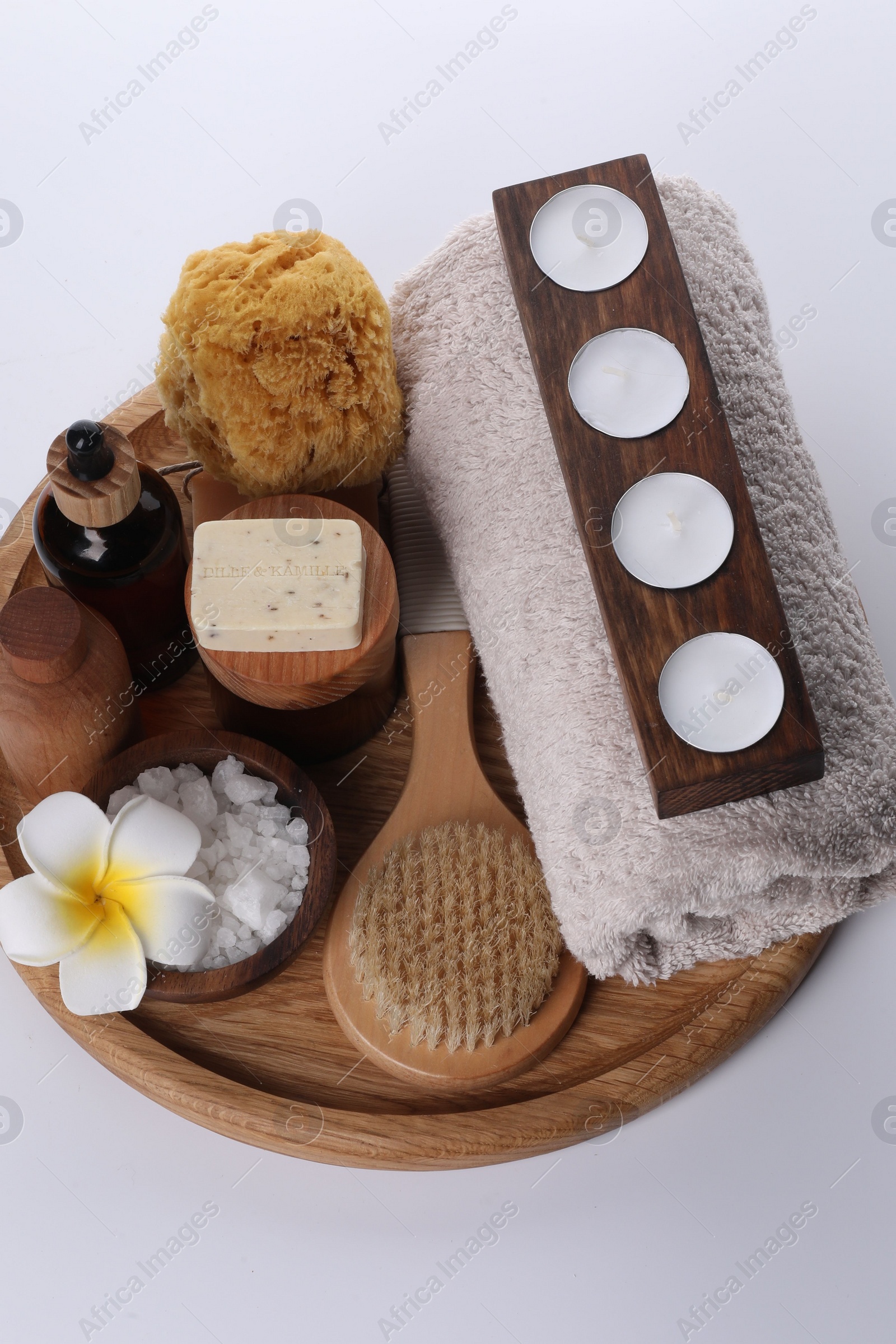 Photo of Composition with spa products, flower and candles isolated on white, above view