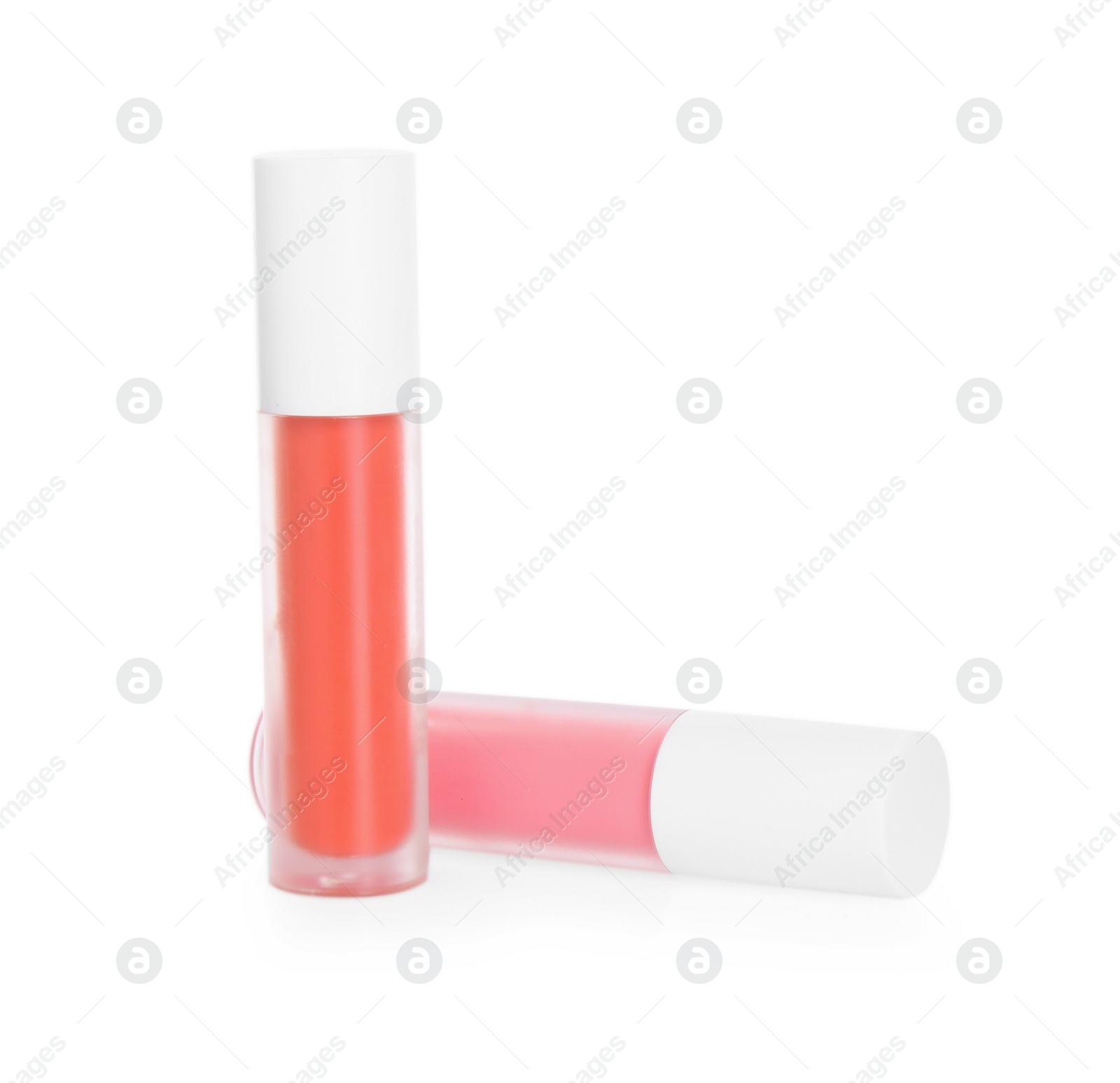 Photo of Two lip glosses isolated on white. Cosmetic products