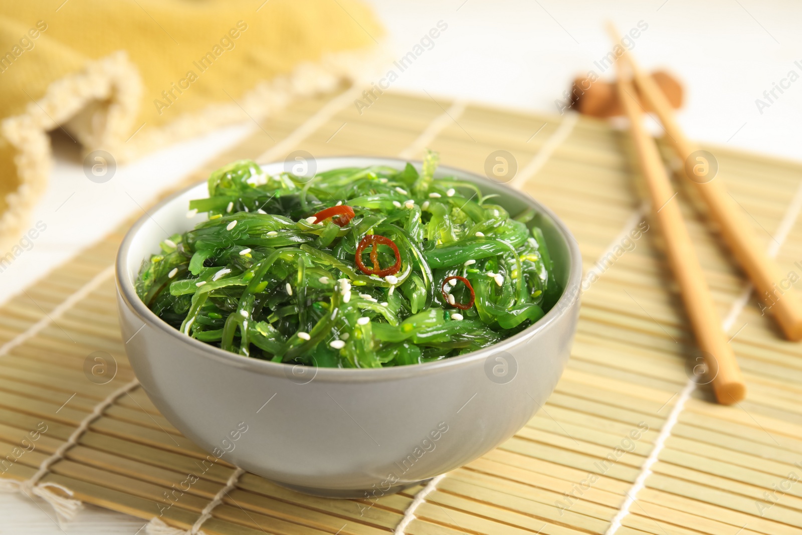 Photo of Japanese seaweed salad served on table, closeup