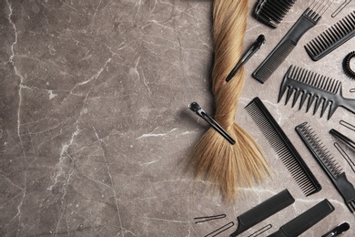 Photo of Flat lay composition with hair salon tools on grey background. Space for text