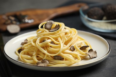 Photo of Tasty fettuccine with truffle on table, closeup