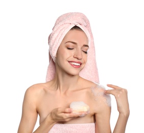 Young woman washing body with soap bar on white background