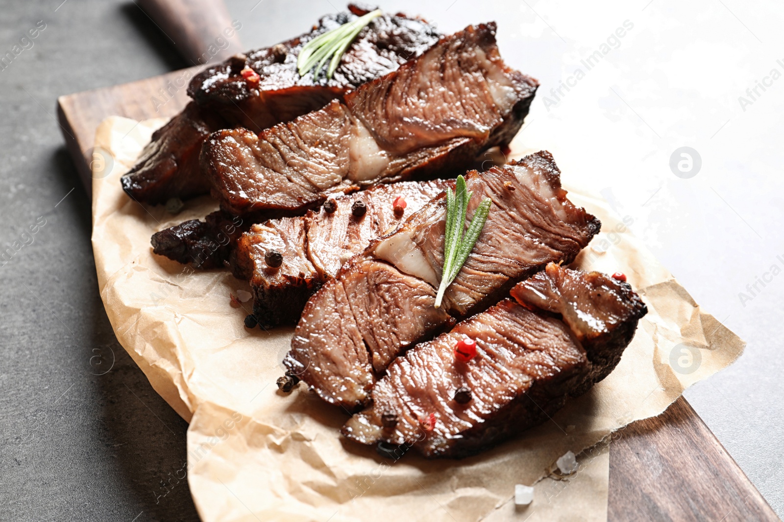 Photo of Delicious meat served for barbecue party on gray table