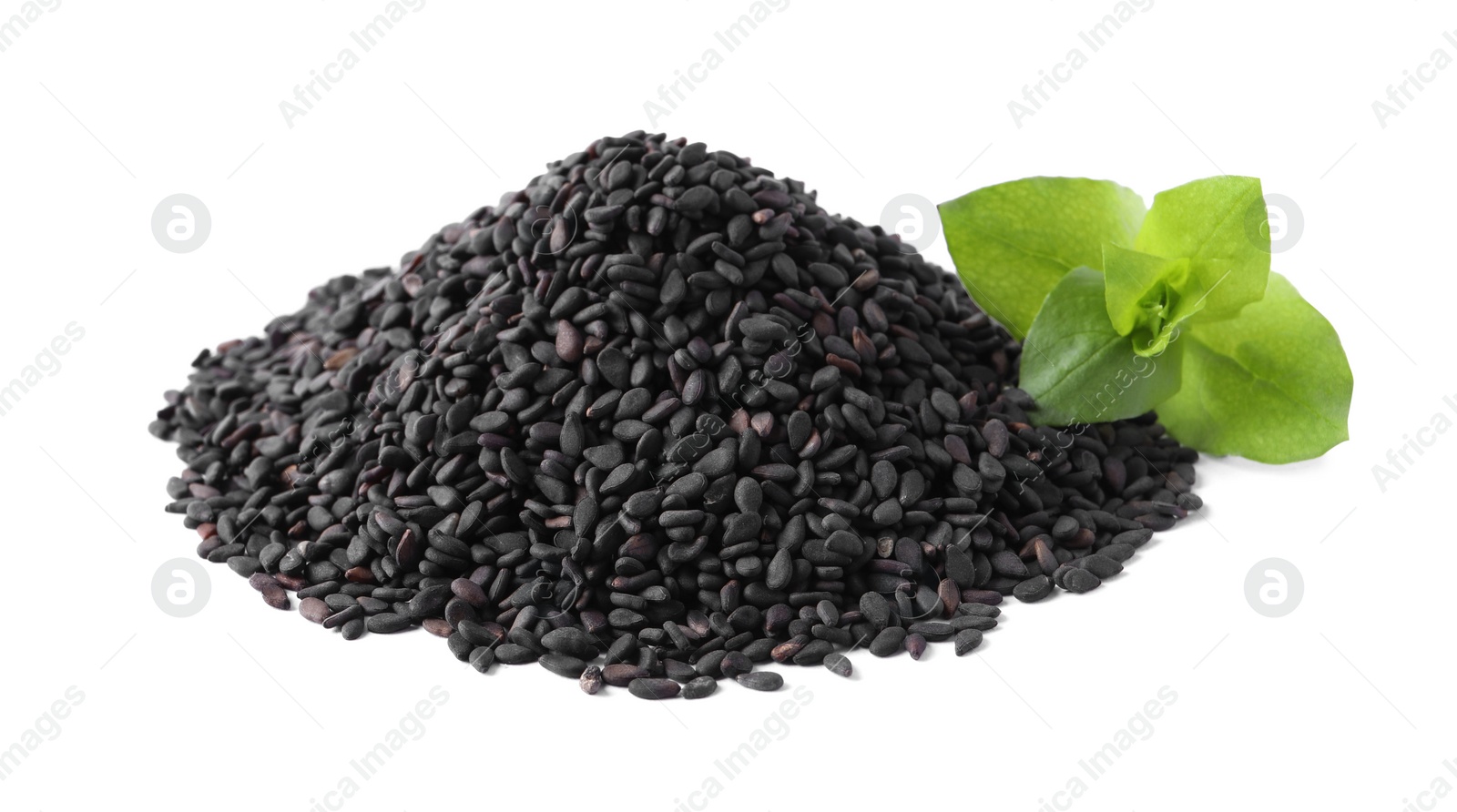 Photo of Pile of black sesame seeds with green leaf on white background