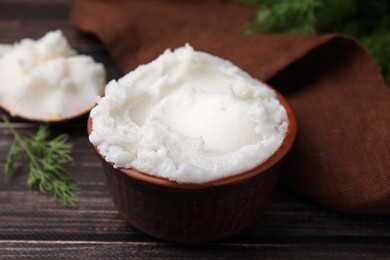 Photo of Delicious pork lard in bowl on wooden table, closeup