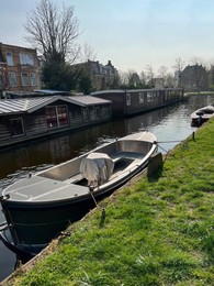 Beautiful city canal with moored boat on sunny spring day