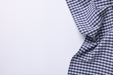 Blue checkered tablecloth on white background, top view