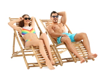 Photo of Young couple on sun loungers against white background. Beach accessories