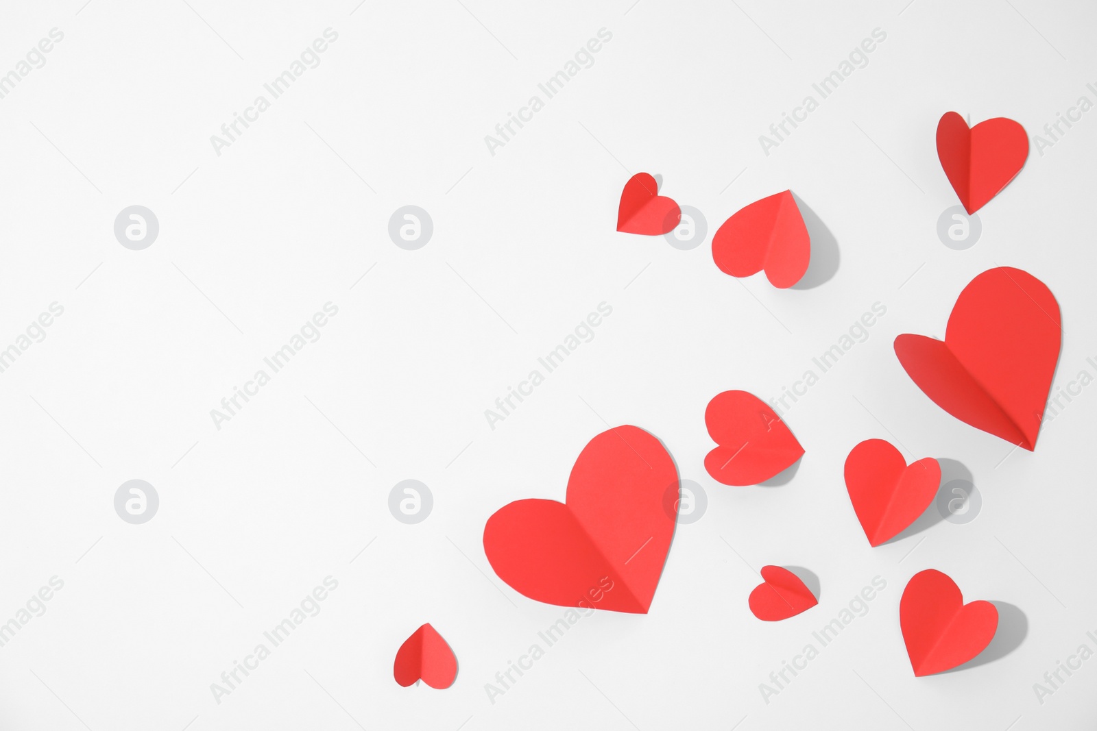 Photo of Small paper hearts on white background