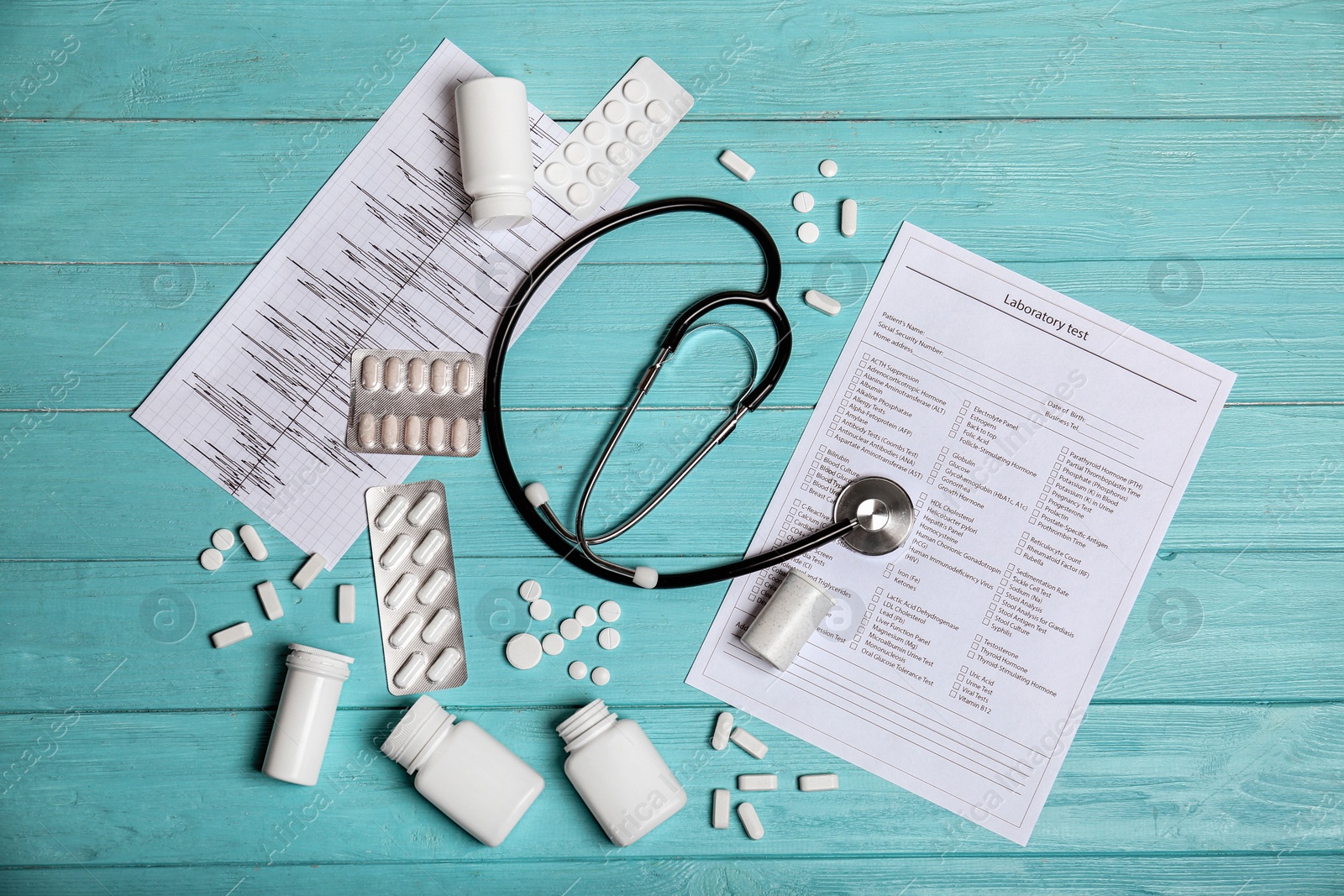 Photo of Flat lay composition with stethoscope and pills on wooden background. Cardiology service