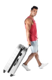 Photo of Young man walking with suitcase on white background