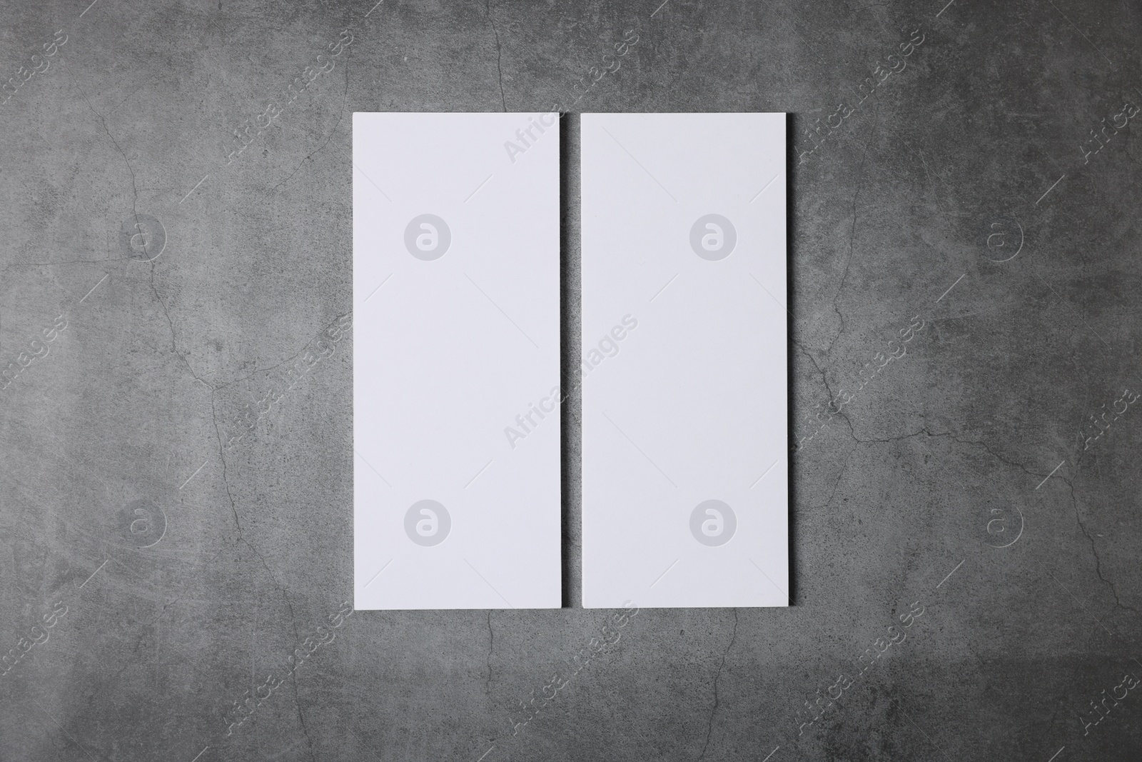 Photo of Blank business cards on grey textured background, top view. Mockup for design