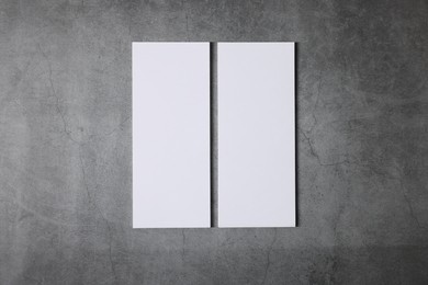 Photo of Blank business cards on grey textured background, top view. Mockup for design