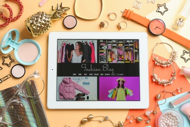 Photo of Flat lay composition with tablet, makeup products and accessories on color background. Fashion blogger