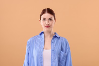 Portrait of beautiful woman on beige background