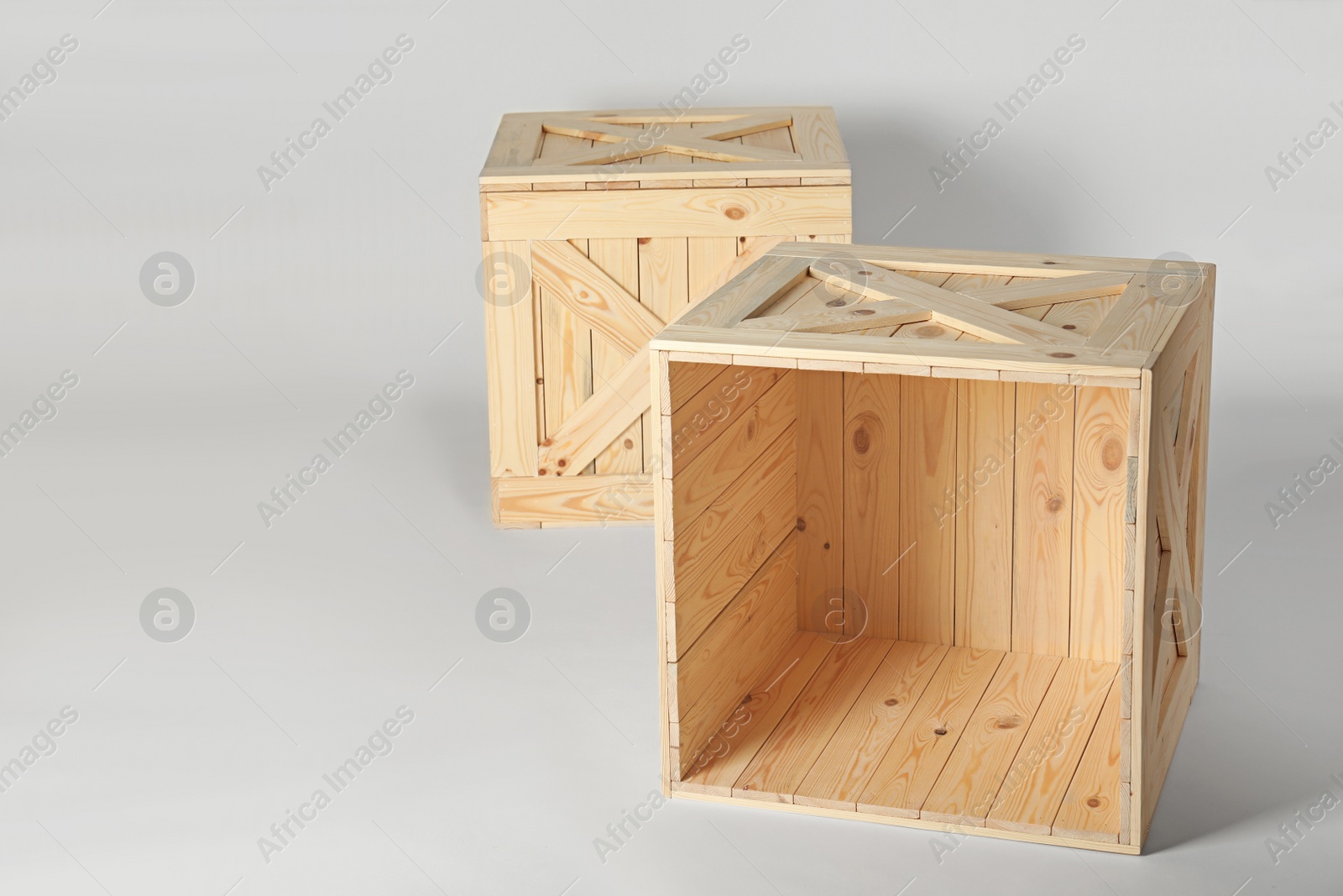 Photo of Wooden crates on light background, space for text. Shipping containers