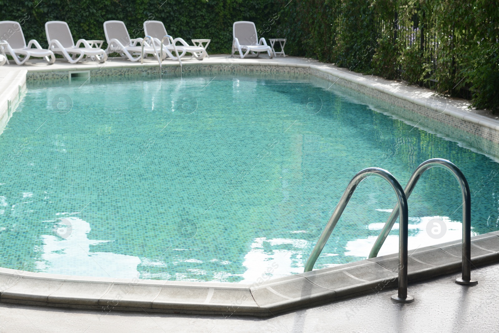 Photo of Ladder with grab bars in outdoor swimming pool