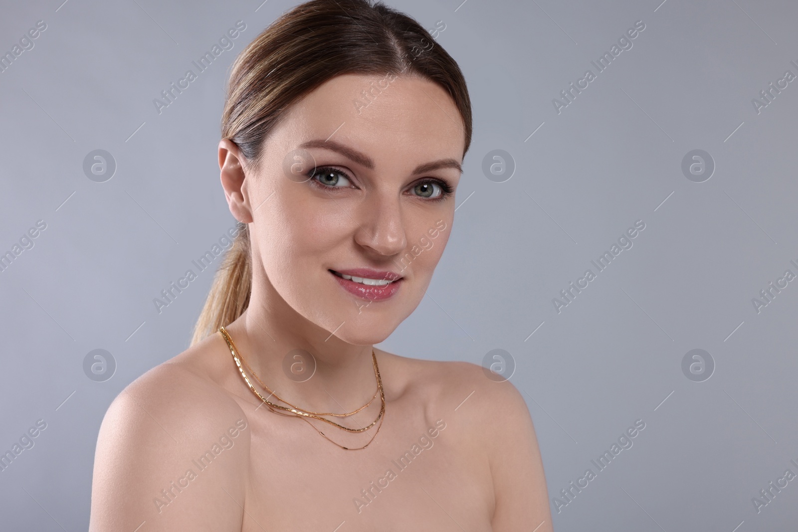 Photo of Beautiful woman with elegant necklace on light grey background. Space for text