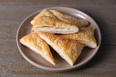 Delicious fresh puff pastries on wooden table