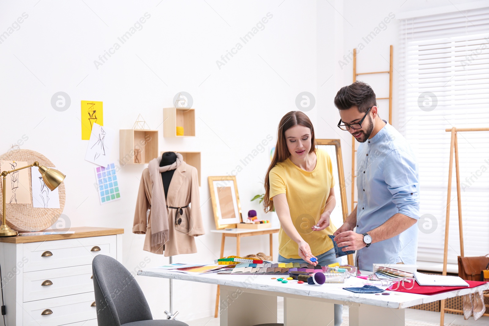 Photo of Fashion designers creating new clothes in studio