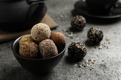 Photo of Delicious vegan candy balls on grey table, space for text