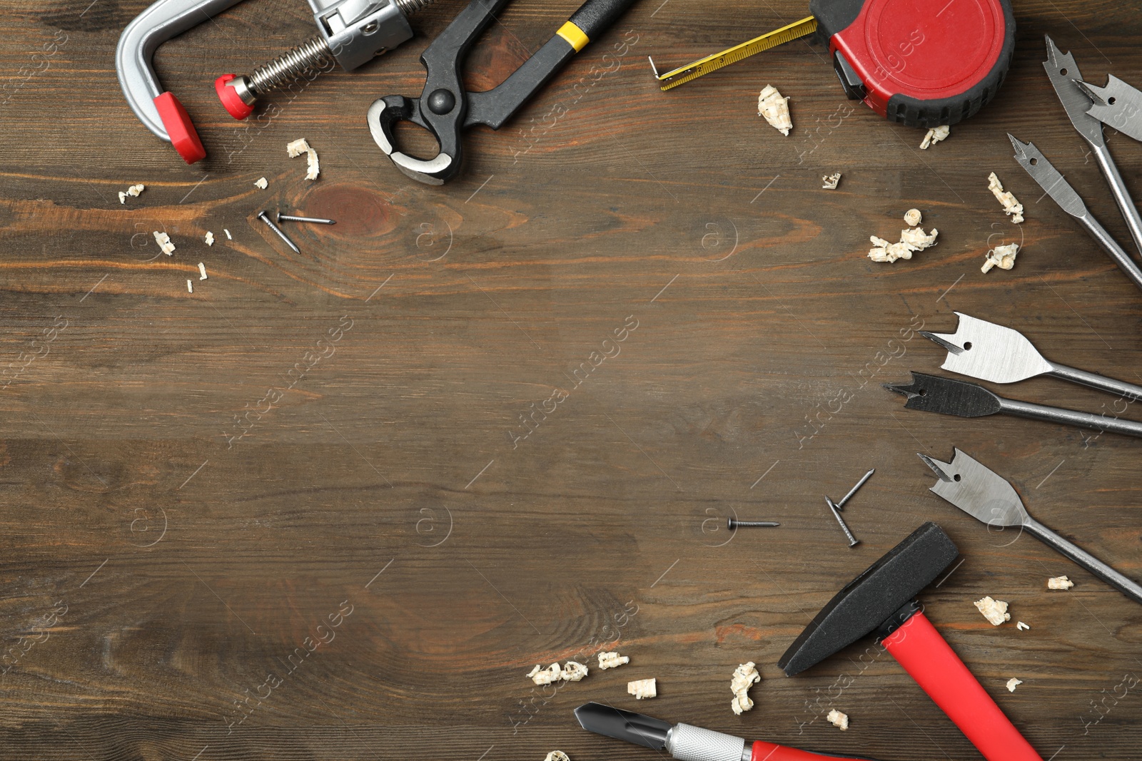 Photo of Flat lay composition with carpenter's tools on wooden background. Space for text