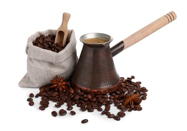 Photo of Metal turkish coffee pot with hot drink, anise stars and beans on white background