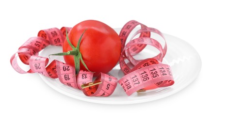 Photo of Measuring tape, plate and fresh tomato isolated on white. Diet concept