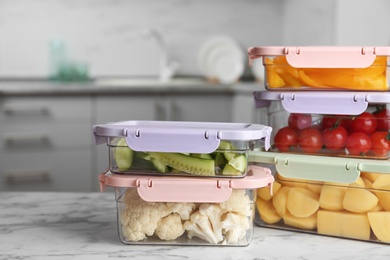 Photo of Boxes with fresh raw vegetables on table in kitchen