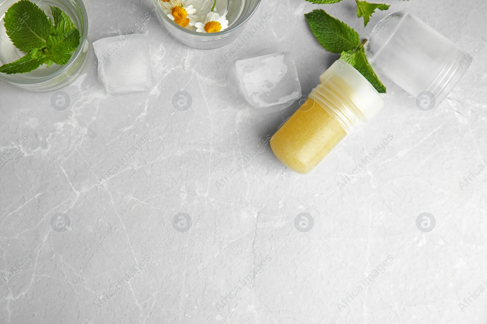 Photo of Flat lay composition with natural crystal alum deodorant and space for text on light grey marble table