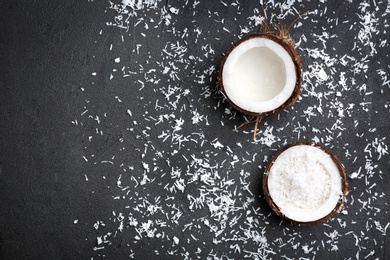 Photo of Composition with fresh coconut flakes on dark background, top view